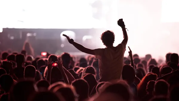 Silhouette of man on shoulders at a rock concert.