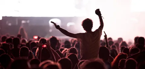 Silhouette of man on shoulders at a rock concert.
