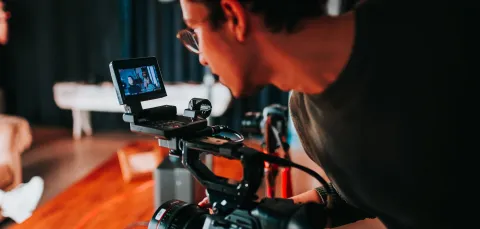 Man holding video camera.
