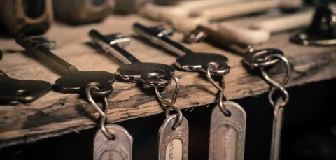 Row of old fashioned keys with labels.