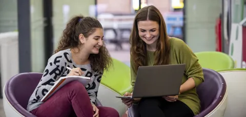 Students in conversation in the student union building.