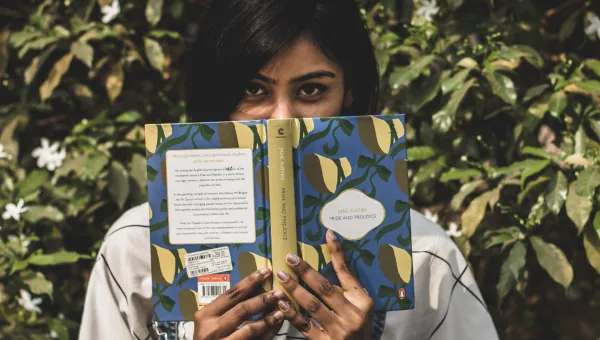 Young woman with a copy of Pride and Prejudice by Jane Austen.