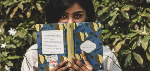 Young woman with a copy of Pride and Prejudice by Jane Austen.