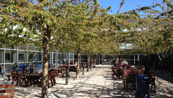 Avenue outdoor courtyard on a sunny spring day with cafe tables.