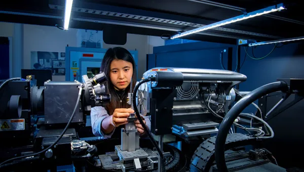 A mechanical engineering student uses a piece of complex machinery