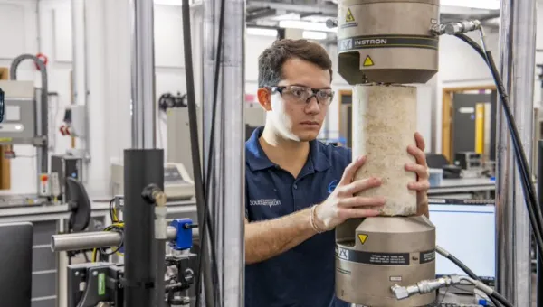 A student tests a concrete structure in the testing and structures research lab