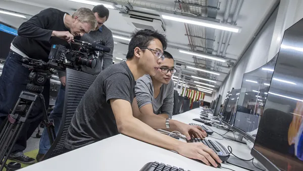 Two students working at a computer in the David Barron computing lab.