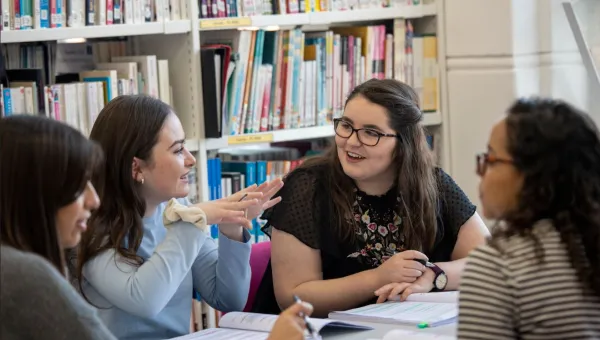 Group of history students in discussion in a library setting