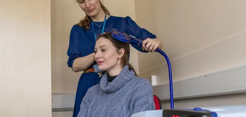 A person using neurostimulation lab equipment