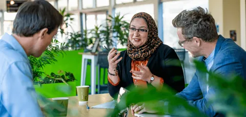 A member of staff having a discussion on campus.
