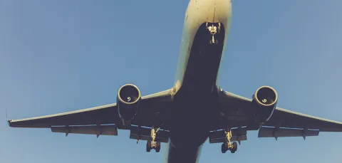 A large passenger plane flying close overhead