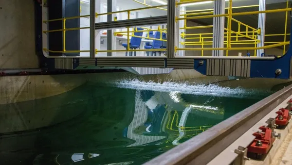 A rogue wave moves along the towing tank, with the carriage sitting above it