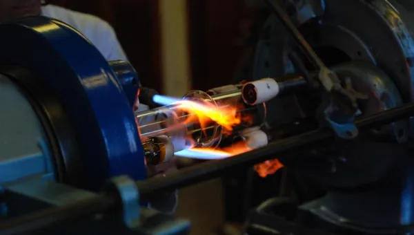 Glassblowing expert creating customised glassware in a workshop