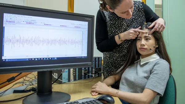 A study participant is prepared for a facial electromyography experiment