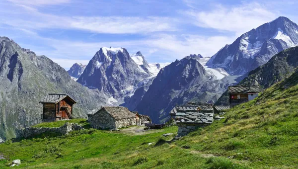 Looking across green fields towards the peaks of the Arolla mountains