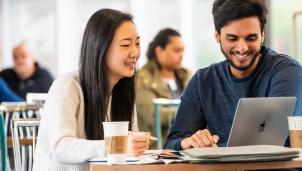 Students working together at a laptop