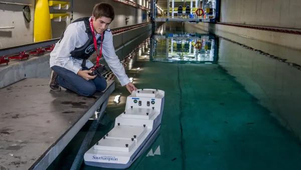 Ship science student Umberto Varbaro tests a model ship in the towing tank