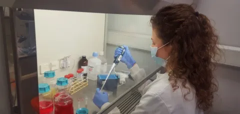 PhD student, Esme Fowkes, conducting research in a laboratory.