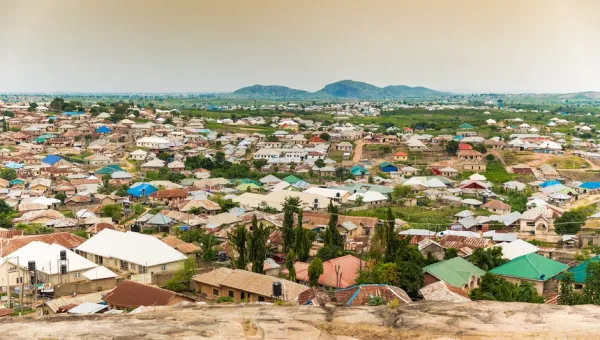 A view of a many large, new houses from a high vantage point on the outskirts of Ado, a settlement that developed due to the expansion of Nigeria's capital of Abuja