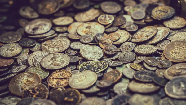 A close-up stock image of various ancient coins.