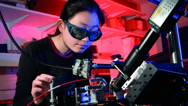 Person in laboratory using laser equipment