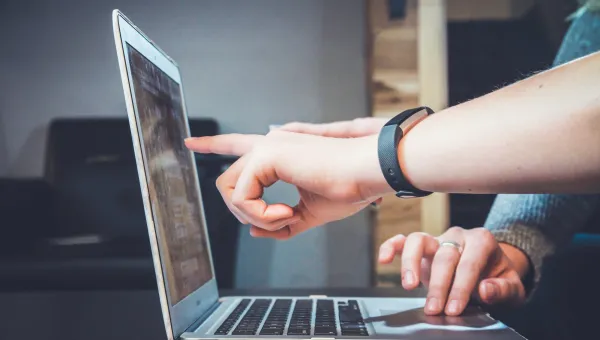 Two people looking at a laptop