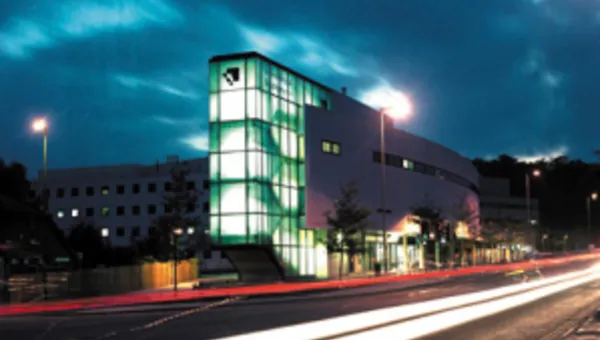 Building with lights shining out in the night