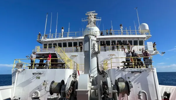crew waving on the bridge of a research vessel