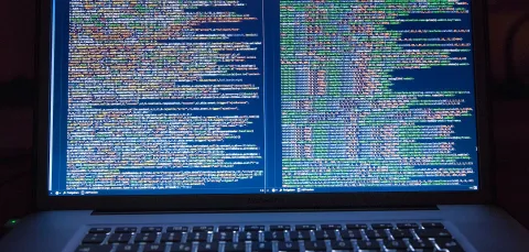 A computer screen, filled with code. We code to develop and deploy machine learning programs