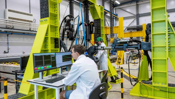 2 researchers with large scale testing equipment