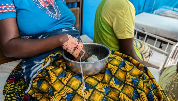 Woman sit on a hospital bed donating blood
