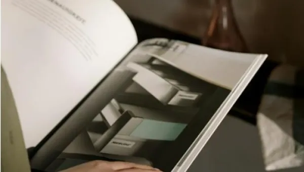A person reading an office furniture catalogue