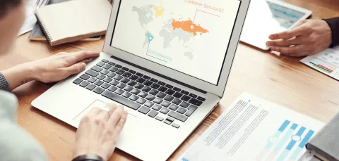 Office meeting on a table with laptop and tablet