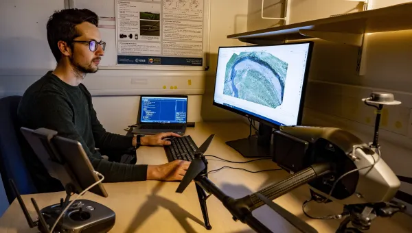 One researcher analysing geospatial data with a computer