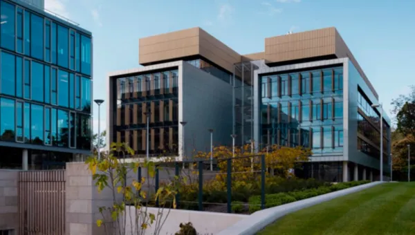 Building 175 on Boldrewood Innovation Campus, a large modern glass and concrete building with lawns and plants to the front