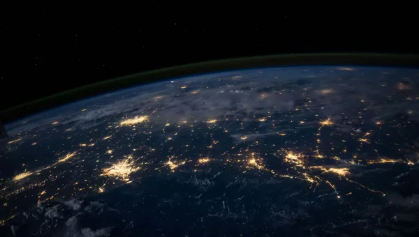 A dark aerial view of earth from outer space