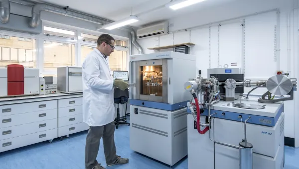 Scientist putting a sample in a spectrometer