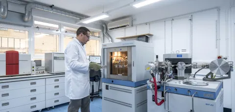 Scientist putting a sample in a spectrometer