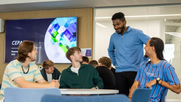 A small group of Southampton Business School students chatting around a table