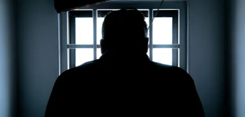 Man on the shadows looking through a window