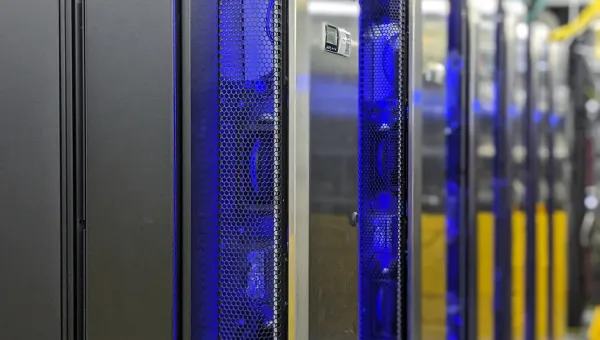 The IRIDIS 6 research computing facility. A series of servers in silver casing with blue and yellow network cables in the background.