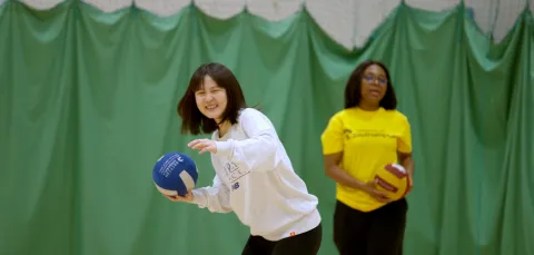 Women practising volleyball throws