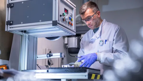 Scientist using laboratory equipment in NNUF-EXACT facility