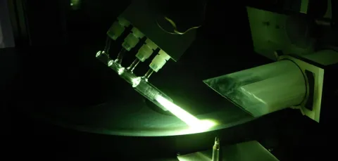 Deposition of a glass layer via flame hydrolysis