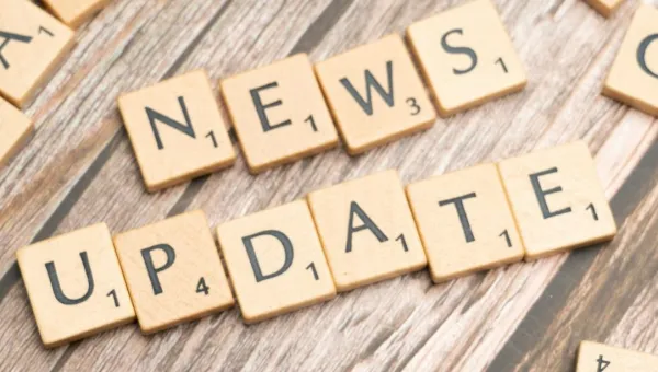 Text reading News Update, made of dominoes letters