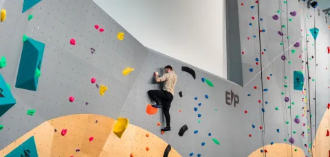 A climber climbing up Southampton University's indoor climbing wall