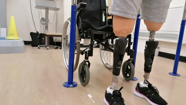 Patient wearing prostehtics infront of wheelchair
