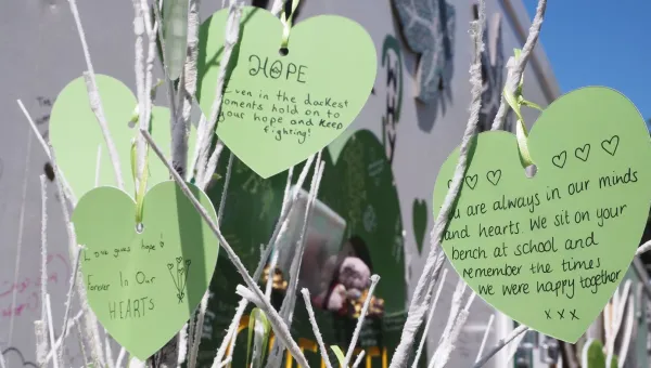 Green paper hearts with mesaages of rememberance for Grenfell Tower victims hearts with 