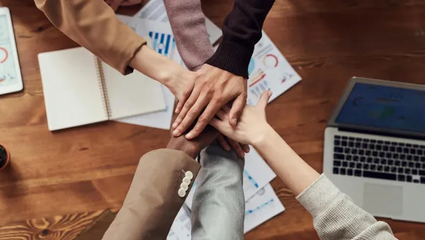Photo of people hands near wooden table