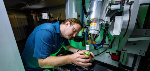 A scientist prepares a specimen to have its x-ray taken.